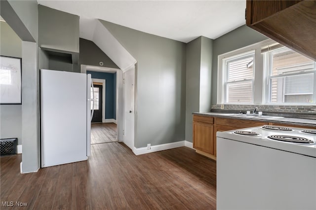 kitchen featuring white appliances, sink, decorative backsplash, and dark hardwood / wood-style flooring