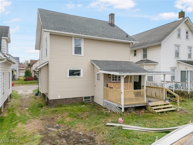 back of property featuring a wooden deck