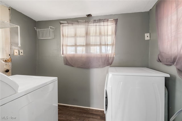 laundry area featuring dark hardwood / wood-style flooring and washer and clothes dryer