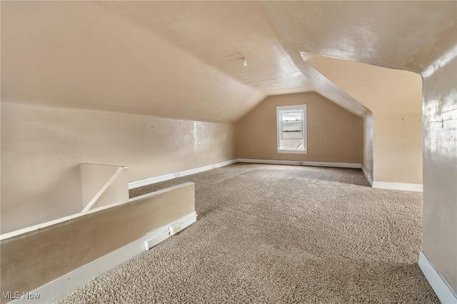 bonus room featuring lofted ceiling and carpet