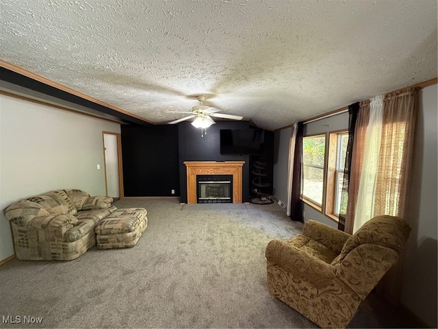 living room featuring ceiling fan, a textured ceiling, and carpet