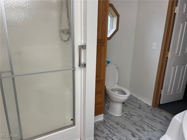 bathroom with toilet and a shower with shower door