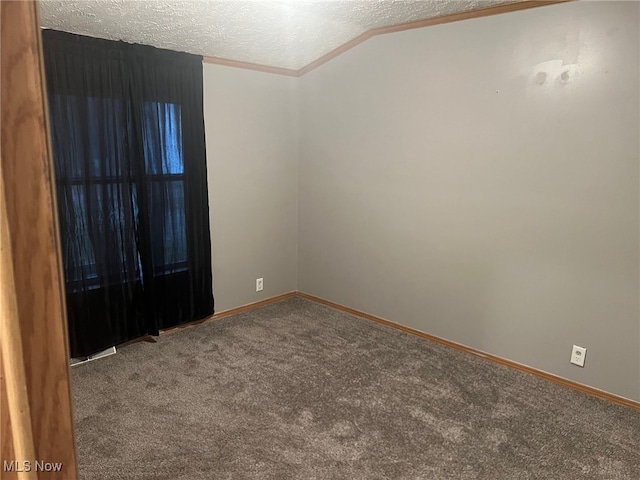 spare room with ornamental molding, carpet, lofted ceiling, and a textured ceiling