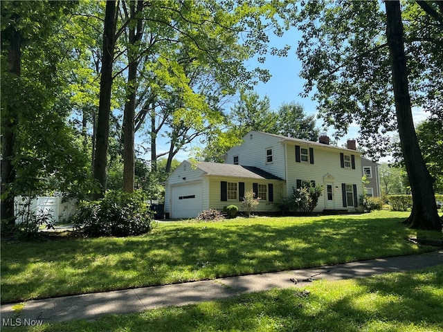 view of front of property with a garage and a front yard