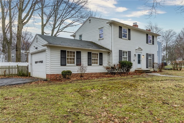 view of front of home featuring a garage and a front lawn