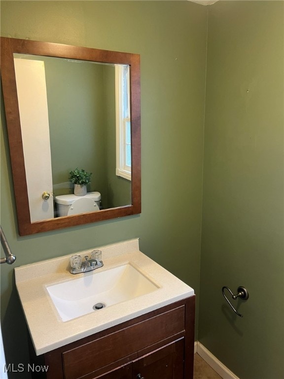 bathroom featuring toilet and vanity