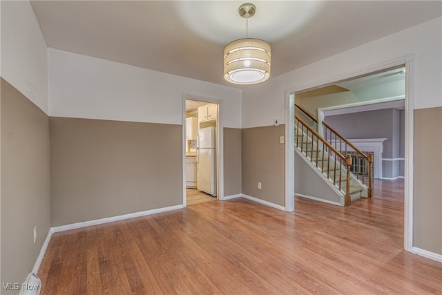 spare room with light hardwood / wood-style flooring