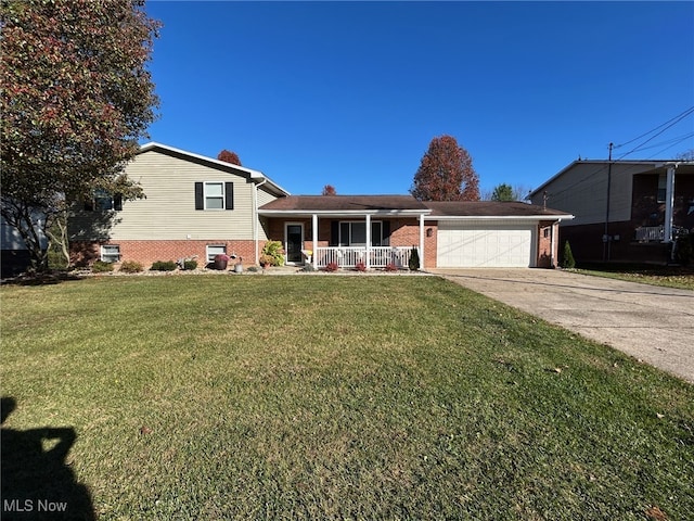 tri-level home featuring a porch, a front yard, and a garage