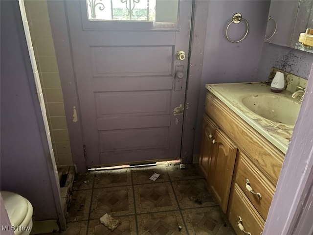 bathroom featuring vanity and toilet