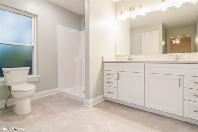 bathroom featuring a shower, ceiling fan, vanity, and toilet