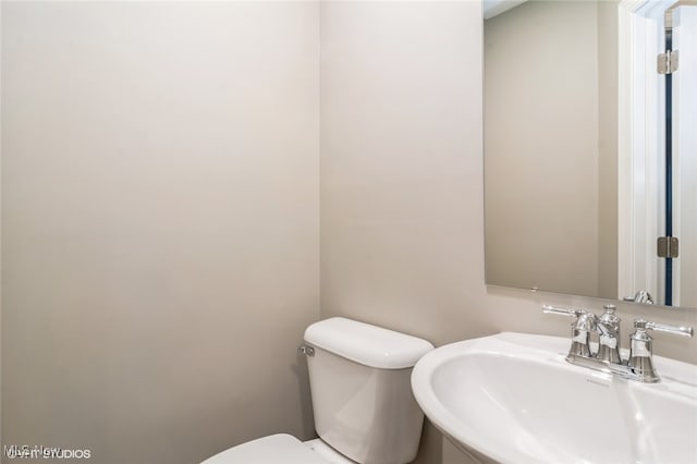 bathroom featuring toilet and sink