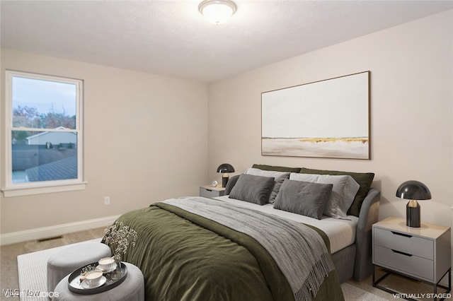 bedroom featuring light colored carpet