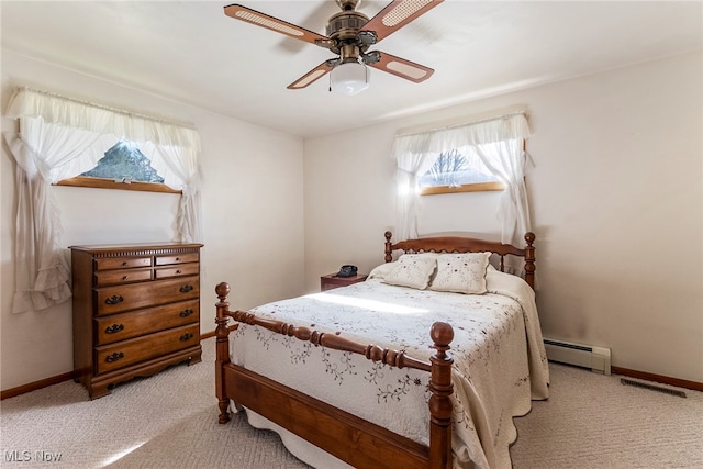 carpeted bedroom featuring baseboard heating and ceiling fan