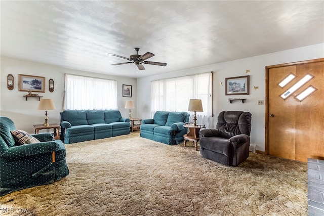 carpeted living room with ceiling fan and plenty of natural light