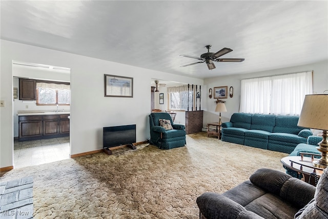 living room featuring ceiling fan and a baseboard heating unit