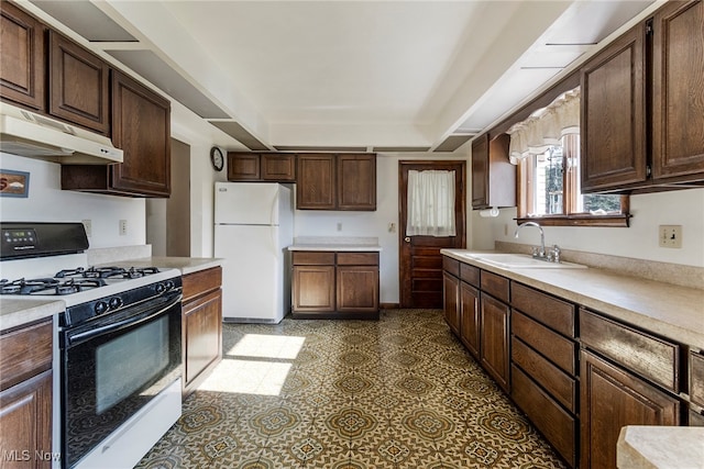 kitchen with white appliances, sink, and dark brown cabinetry