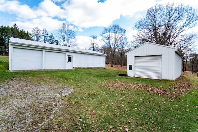 view of yard featuring an outbuilding and a garage