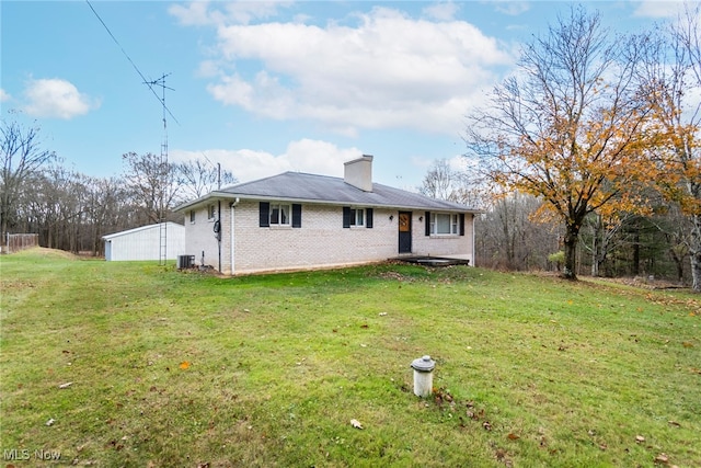 exterior space featuring cooling unit and a front lawn