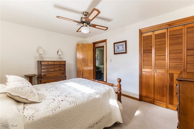 bedroom featuring a closet, light colored carpet, and ceiling fan