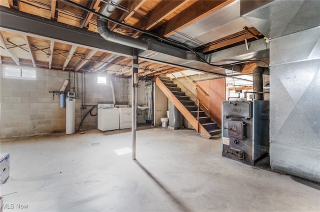 basement with a wealth of natural light, washing machine and dryer, and heating unit