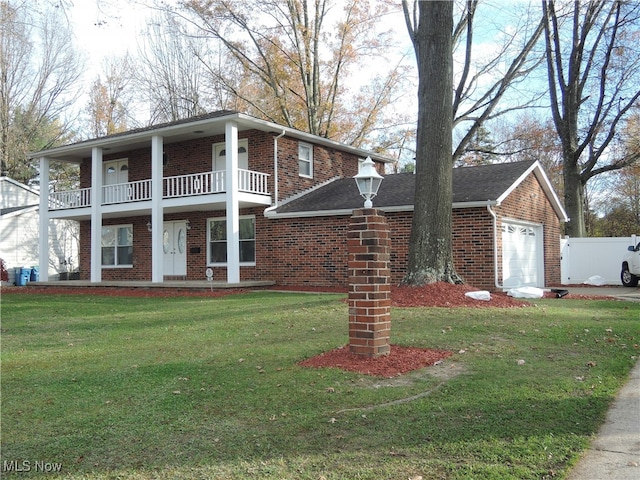 view of front of home featuring a garage, a front lawn, and a balcony