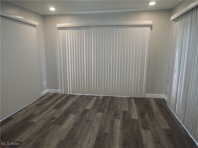 empty room featuring dark hardwood / wood-style flooring