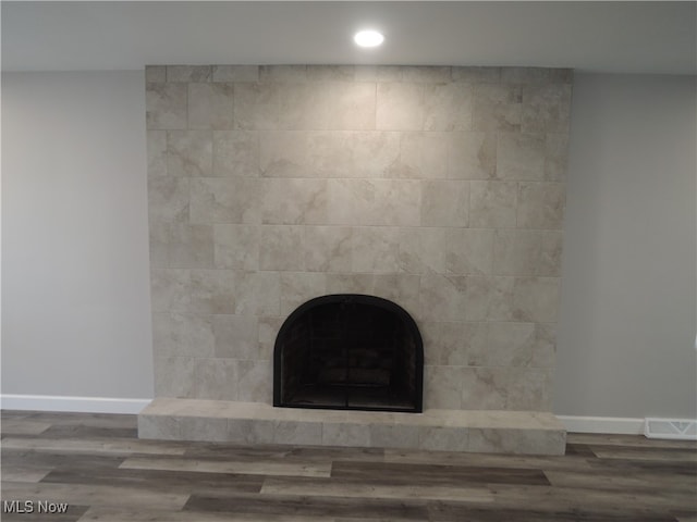 room details with hardwood / wood-style floors and a fireplace