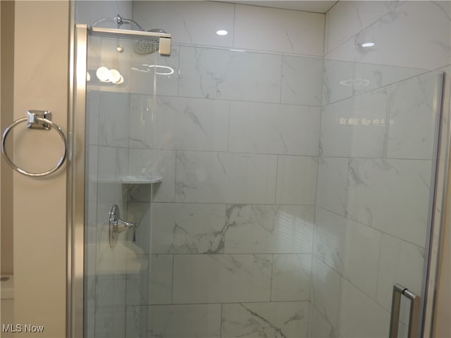 bathroom with a shower with shower door