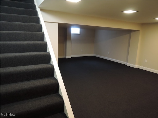 basement with dark colored carpet