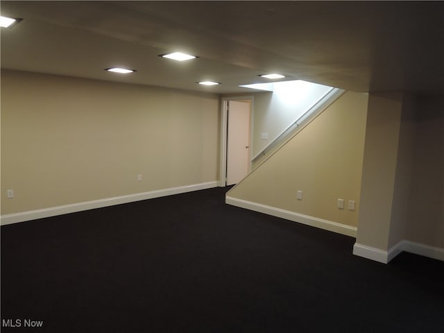 basement featuring dark colored carpet