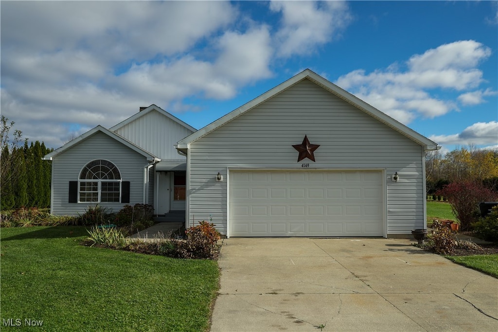 view of front of home with a garage and a front lawn