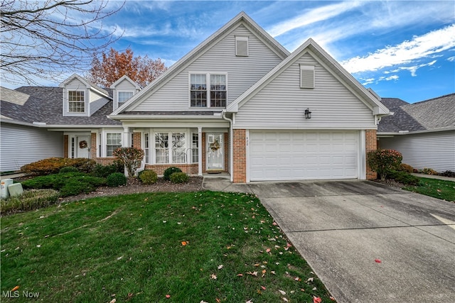 view of front of property with concrete driveway, a garage, brick siding, and a front yard