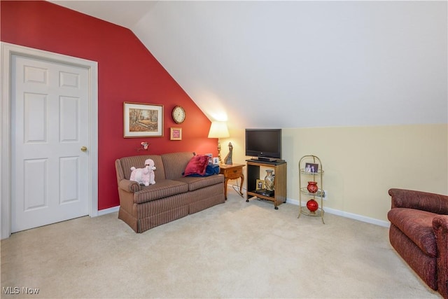 carpeted living room with lofted ceiling and baseboards