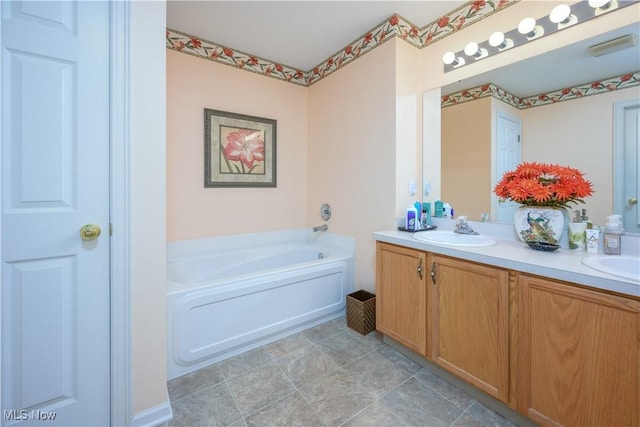 full bathroom with a sink, a bath, and double vanity
