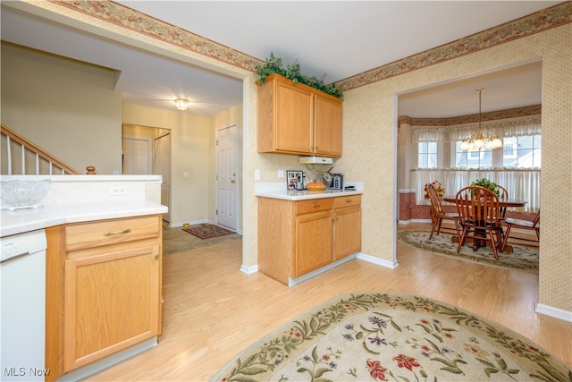 kitchen featuring wallpapered walls, light wood-style floors, white dishwasher, and baseboards