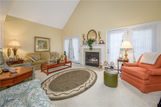 living room with high vaulted ceiling and a fireplace