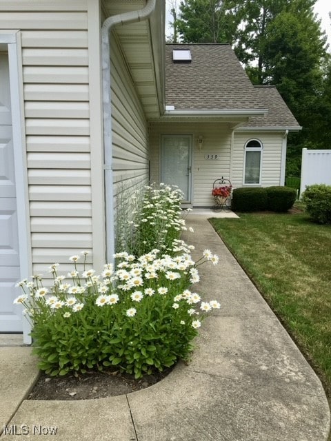 doorway to property featuring a lawn