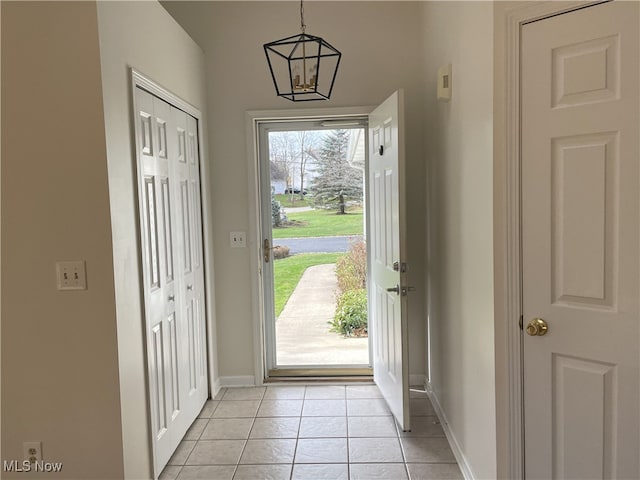 entryway featuring a chandelier and light tile patterned floors