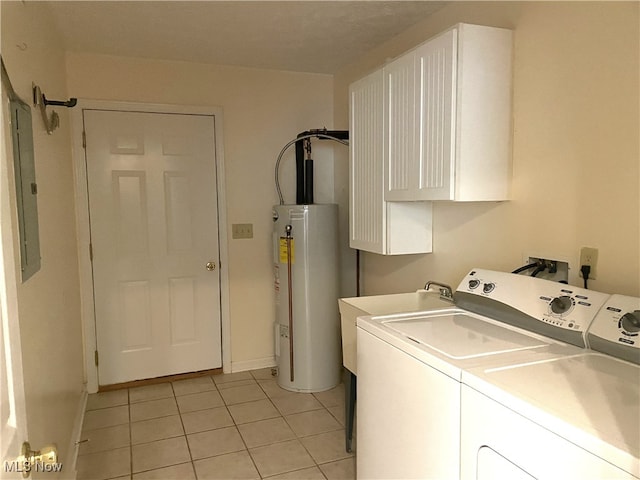 laundry area featuring electric water heater, separate washer and dryer, light tile patterned floors, and cabinets