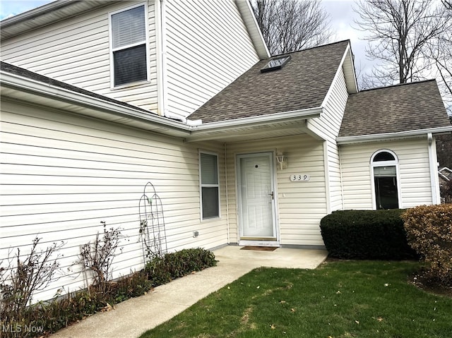 view of exterior entry featuring a yard