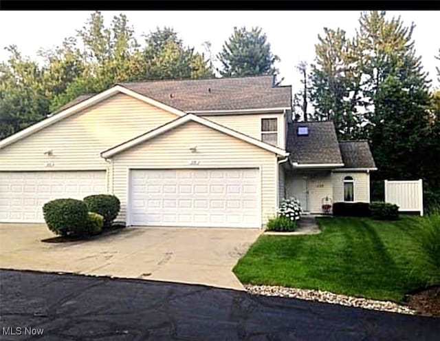 view of front property with a garage and a front yard