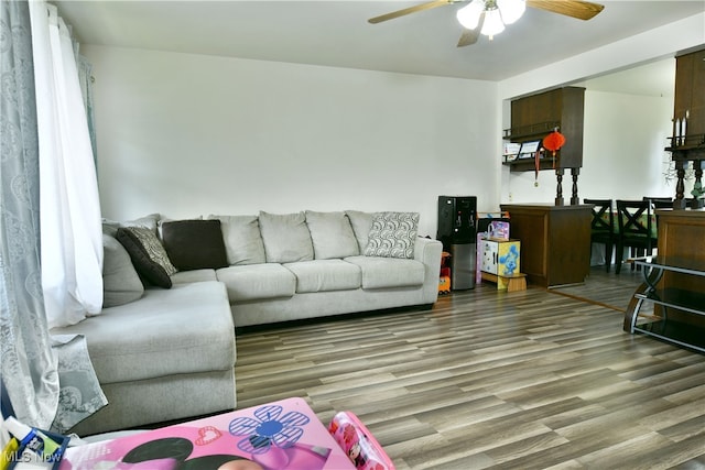 living room with hardwood / wood-style floors and ceiling fan