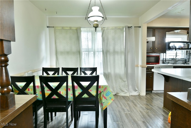 dining area with light wood-type flooring and sink