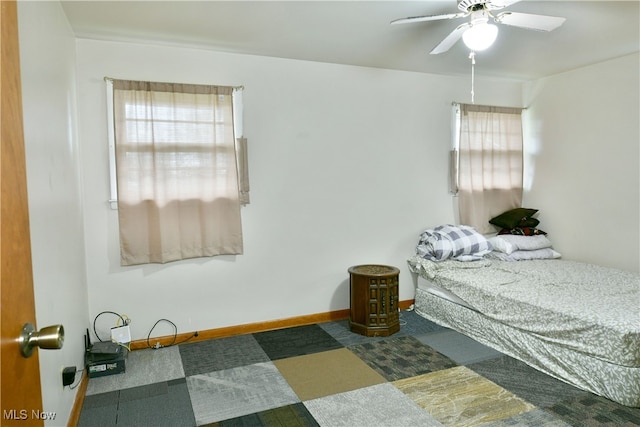 bedroom featuring multiple windows, carpet, and ceiling fan