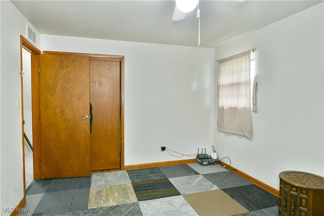 carpeted bedroom featuring ceiling fan and a closet