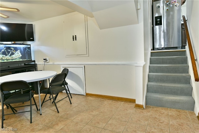 tiled office space featuring ceiling fan