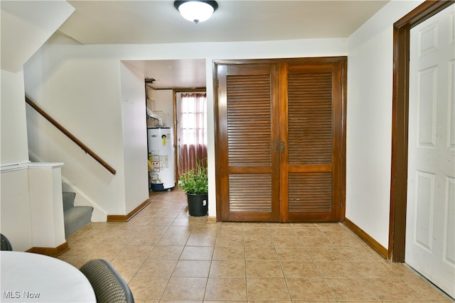 entrance foyer with gas water heater and light tile patterned floors