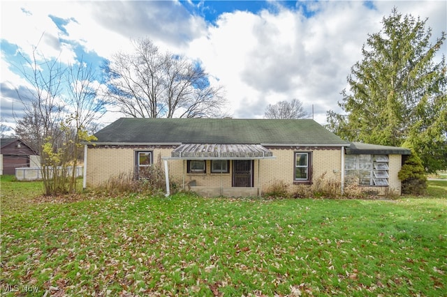 back of house with a lawn