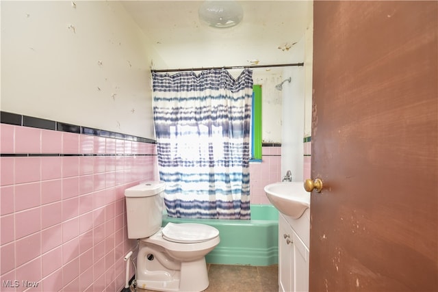 full bathroom featuring tile walls, vanity, shower / bath combo with shower curtain, and toilet