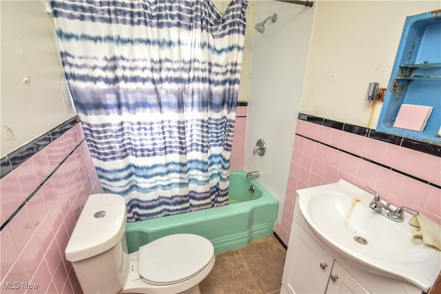 full bathroom featuring toilet, tile walls, tile patterned flooring, vanity, and shower / bathtub combination with curtain